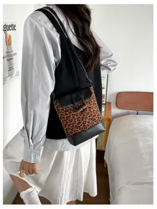 Stylish leopard print bucket bag with leather trim and toggle closure for daily fashion.