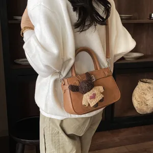 Women brown matte shoulder bag commuting handbag with bear pendant, stylish crossbody bag main view