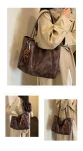 Detail view of brown leopard print tote shoulder bag with cute bear keychain accessory.