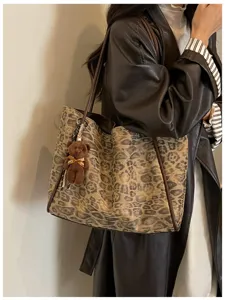 Leopard print tote bag detail showing stylish retro shoulder bag design with cute bear charm.