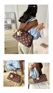 Stylish brown polka dot shoulder bag with cute bear pendant, large capacity commuter tote bag.