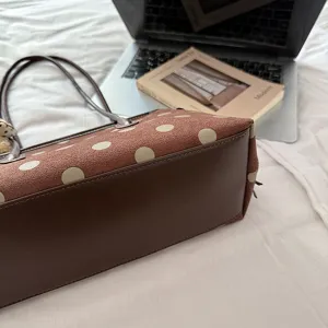 Detailed view of the stylish polka dot brown shoulder tote bag showing texture and design.