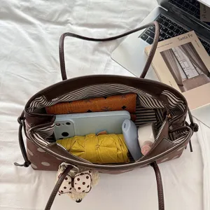Brown polka dot tote shoulder bag interior detail showing large capacity commuting design.