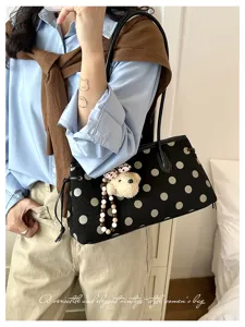 Stylish black polka dot shoulder bag for women, elegant vintage tote bag with cute bear charm.