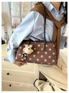 Elegant vintage brown polka dot underarm shoulder bag with cute plush bear charm for daily commute.