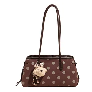 Brown polka dot shoulder bag with cute plush bear pendant, stylish commute tote bag for women.