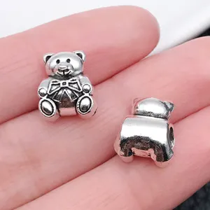 Detailed close-up of cute silver teddy bear large hole charm bead for DIY handmade bracelets.