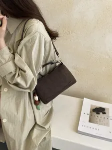 Detailed view of stylish dark brown shoulder handbag, perfect for daily commute and casual chic outfits.