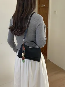 Stylish black commuter shoulder bag with bead pendant, versatile everyday crossbody purse.