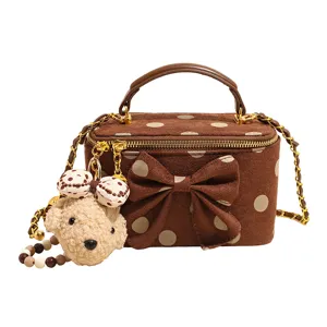 Brown polka dot vanity bag with bow and cute teddy bear pendant, stylish chain crossbody.