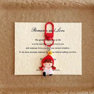 Cute cartoon little girl keychain bag charm with red hat and plaid dress for students.