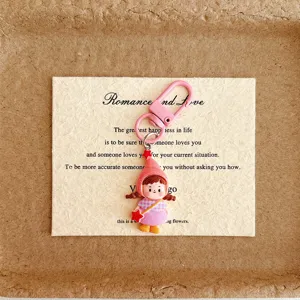 Detailed shot of cute cartoon girl keychain pendant with pink hook, perfect bag charm accessory.