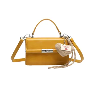Yellow women's shoulder handbag crossbody small square bag, elegant daily style detail.