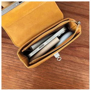 Detail view of yellow PU leather crossbody shoulder bag showing interior storage capacity.
