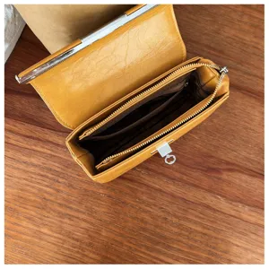 Stylish yellow women's crossbody bag with metal lock detail, perfect for daily commuting needs.