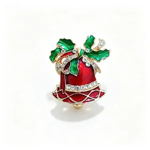 Close up view of exquisite Christmas bell brooch with vibrant red green enamel and crystal rhinestones.