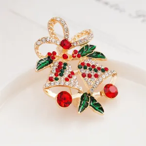 Detailed close-up of a charming Christmas bell and bow brooch, sparkling crystal rhinestones.