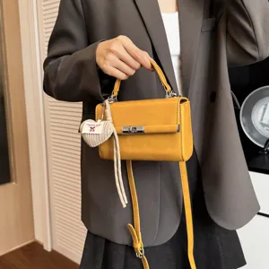 Women yellow shoulder crossbody handbag stylish pu leather mini square bag with heart charm.