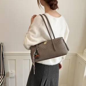 Stylish woven shoulder bag for women, chic baguette design, neutral grey-brown tone, elegant daily use.