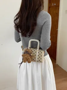 Chic polka dot shoulder bag for women, cute boston pillow bag with fluffy bear pendant.
