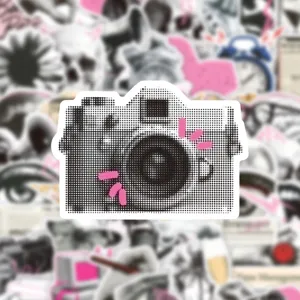 Close-up detail of a retro halftone camera sticker, perfect for DIY journaling and crafts.