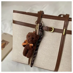 Large capacity canvas tote bag with cute bear pendant, retro color-blocking handbag.