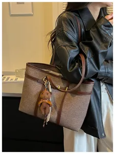 Detailed view of large capacity vintage patchwork tote bag with cute bear charm for daily use.