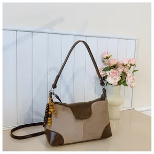 Detailed view of chic retro color-block shoulder underarm bag with cute wooden beaded charm.