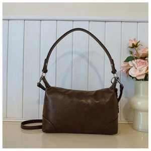 Retro brown shoulder bag for women, PU leather underarm tote bag for daily commute and fashion wear.