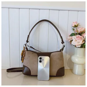 Vintage brown suede shoulder bag for women, stylish underarm commuting tote with chic strap.