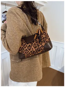 Retro leopard print shoulder underarm bag for women, chic vintage design with beaded pendant.
