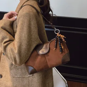 Vintage brown suede shoulder bag for women, chic underarm bag with wooden bead charm.