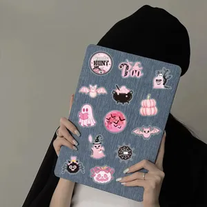 Close-up detail of cute pink Halloween stickers featuring spooky ghost and pumpkin designs.