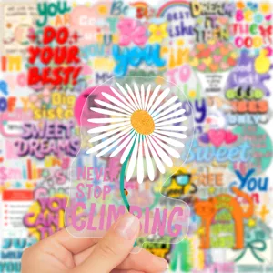 Detail shot of a clear PET daisy sticker featuring inspirational text and a cute ladybug.