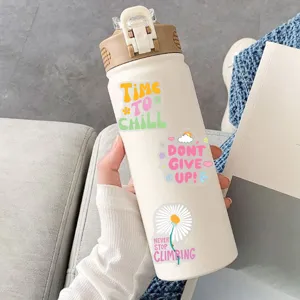 Close-up of motivational English PET stickers applied on a white water bottle in lifestyle.