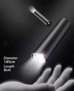 Compact mini flashlight detail, matte black metal body, portable EDC pocket torch lighting.
