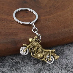 Retro metal motorcycle keychain pendant detail, vintage hip-hop style fashion men accessory.
