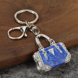 Silver metal keychain with blue enamel handbag pendant and sparkling rhinestones.