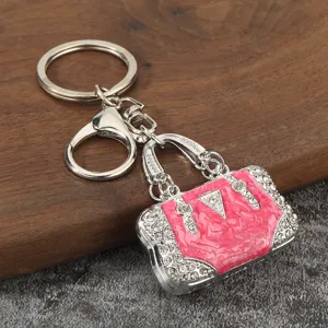 Metal rhinestone handbag keychain detail, stylish pink enamel bag charm keyring for backpacks.