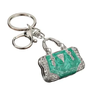 Metal rhinestone handbag keychain front view, luxury green oil drop key ring pendant accessory.