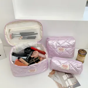 Detailed view of shiny pink quilted makeup bags set, featuring spacious storage and neat zipper.