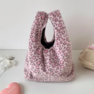 Detailed shot of fluffy pink leopard print handbag, soft plush texture, stylish daily tote bag.
