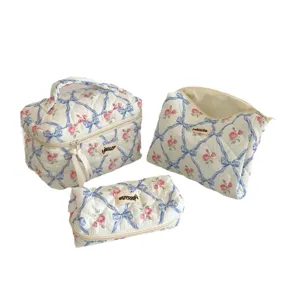 Quilted cosmetic bag set with blue bow and rose pattern, portable makeup storage pouches.