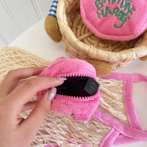 Plush mini coin purse detail showing soft pink texture, zipper closure and cute makeup storage.