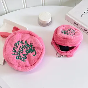 Pink fluffy plush coin purse mini earphone storage bag with cute green embroidery details.