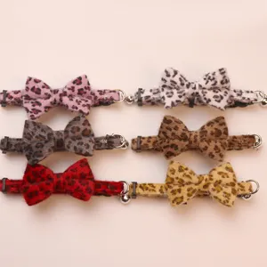 Plush leopard bow pet collar detail showing soft fabric texture, cute bell and adjustable buckle.