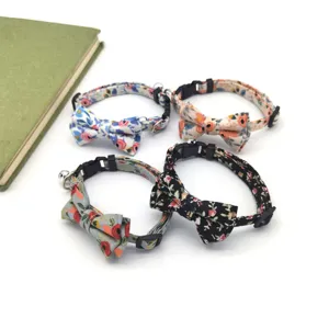 Detailed view of floral cat collars with bowties and bells, cute pet accessories for daily wear.