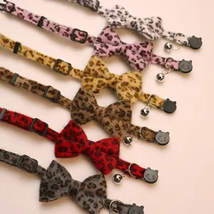 Plush leopard print cat collar detail view with cute bow, bell and safety buckle.