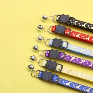 Cute cat collar with gold foil moon star print, safety breakaway buckle and bell.