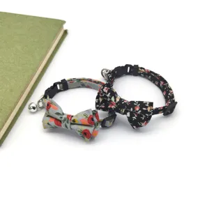 Detailed view of floral cat collar featuring cute bow tie, metal bell and secure buckle.